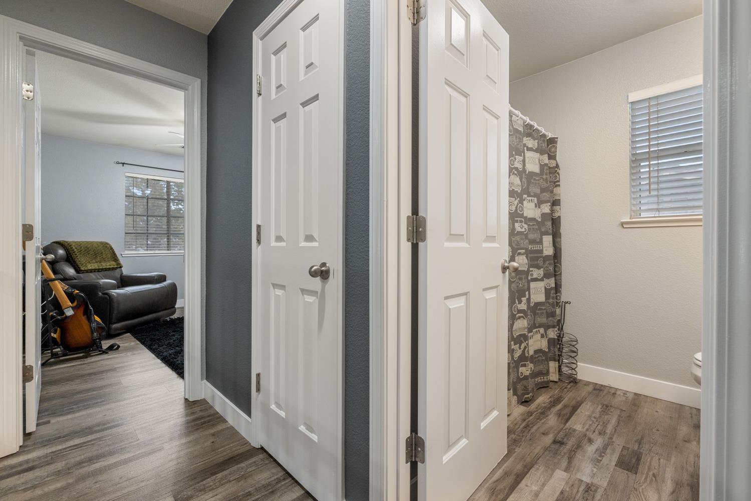 818 Travaille Way Ripon, CA 95366 - Photo 39 of 52 a view of a hallway with wooden floor and a livingroom