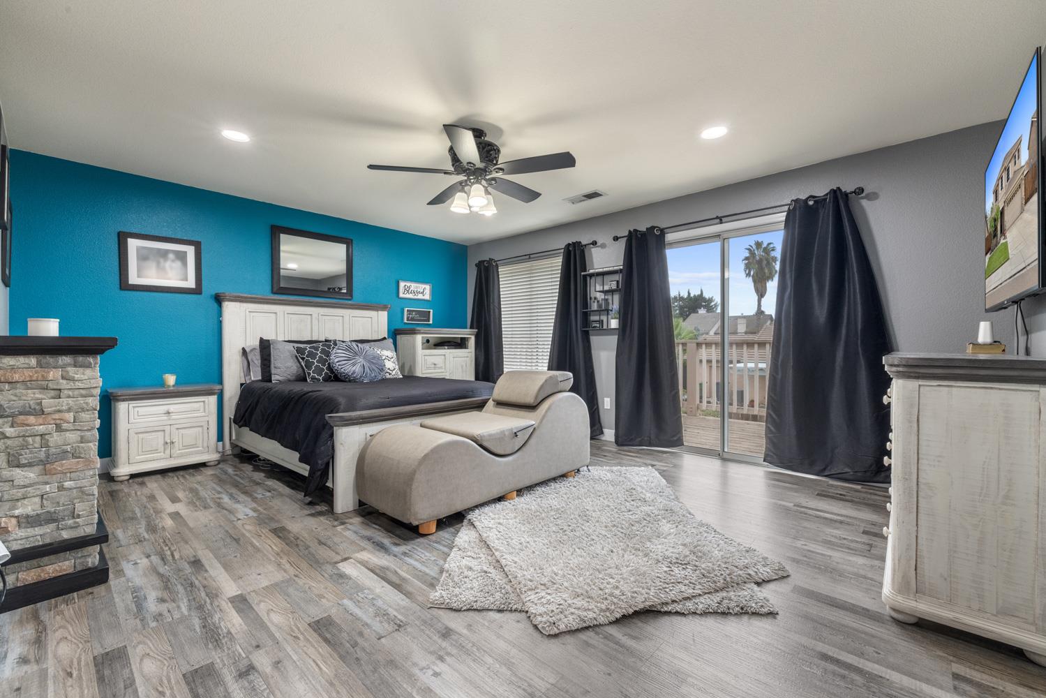 818 Travaille Way Ripon, CA 95366 - Photo 41 of 52 a spacious bedroom with a large bed and a chandelier