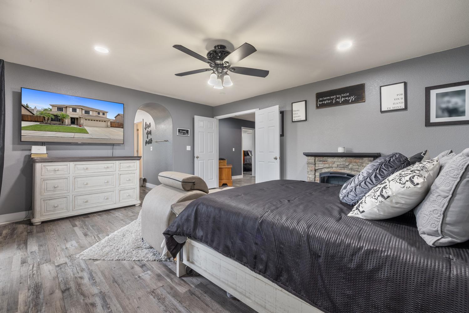 818 Travaille Way Ripon, CA 95366 - Photo 42 of 52 a bedroom with a large bed and a chandelier