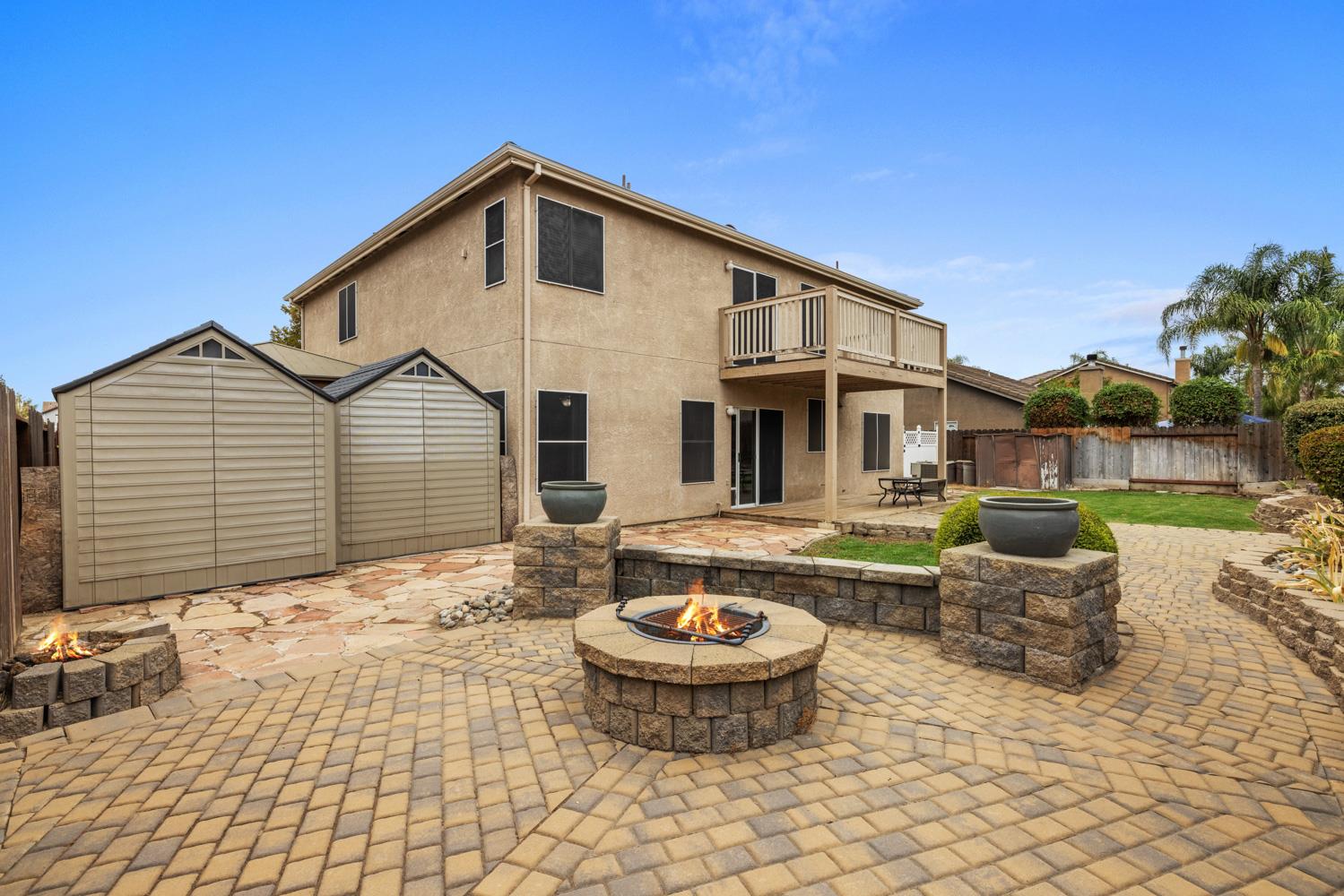 818 Travaille Way Ripon, CA 95366 - Photo 50 of 52 a front view of a house with swimming pool and sitting area