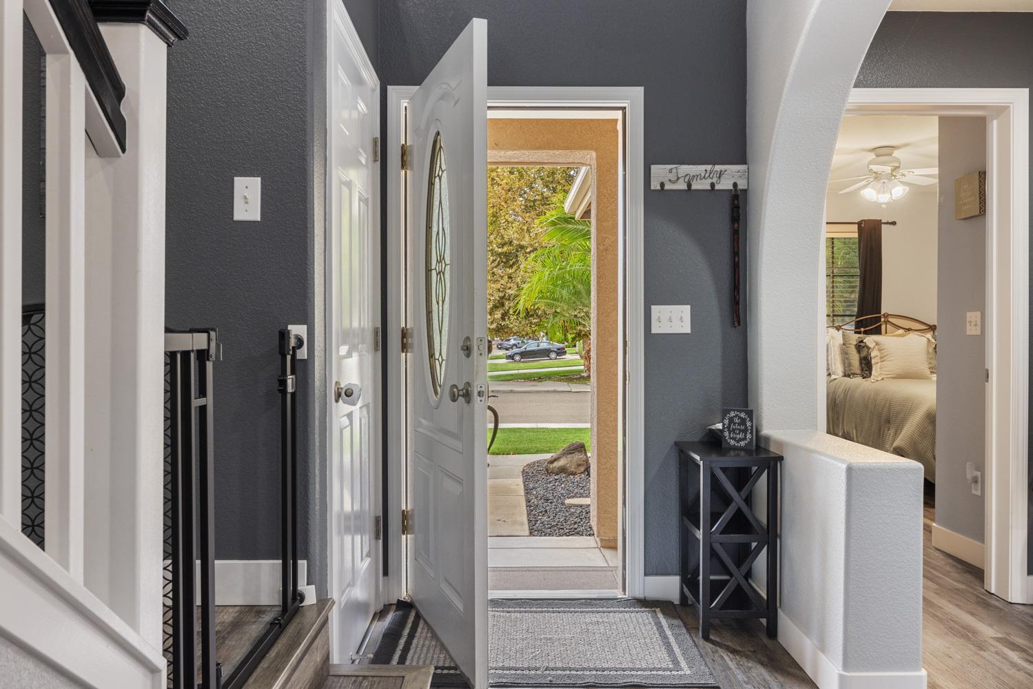 818 Travaille Way Ripon, CA 95366 - Photo 5 of 52 a view of a hallway with a view of bedroom with a bed and a mirror