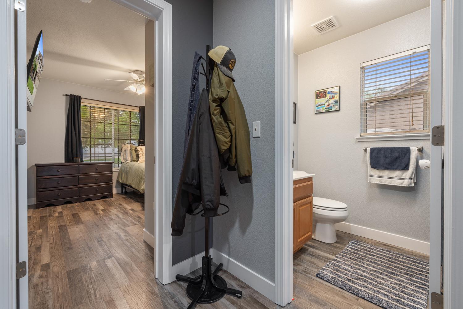 818 Travaille Way Ripon, CA 95366 - Photo 8 of 52 a bathroom with a toilet a sink and a mirror