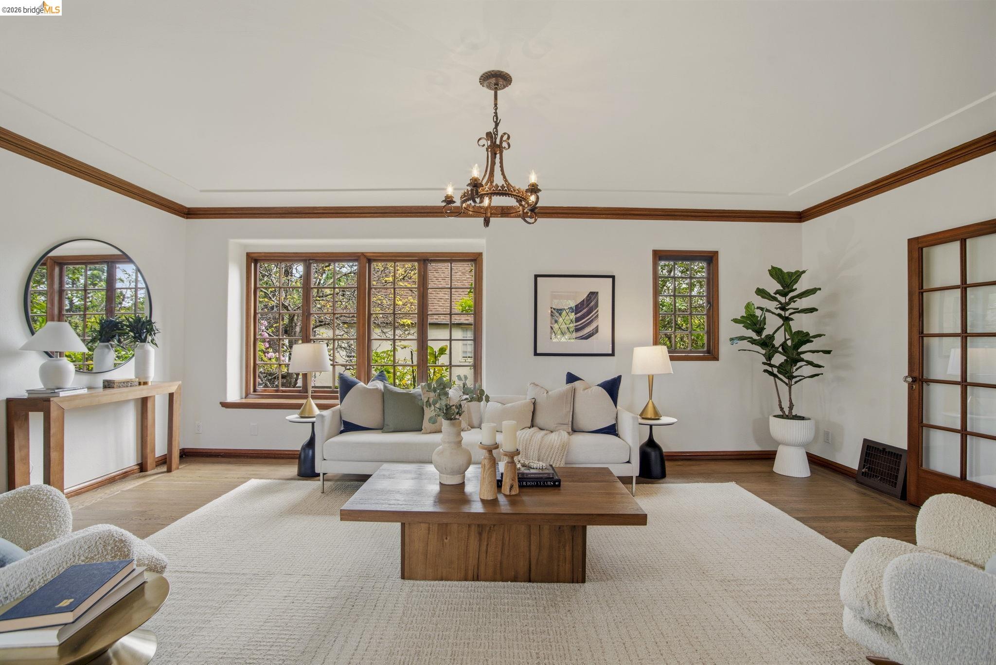 1087 Hubert Road Oakland, CA 94610 - Photo 46 of 67 Living room featuring wood-finish flooring, white walls, and dark wood trim