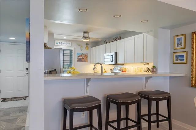 a dining room with furniture a chandelier and window
