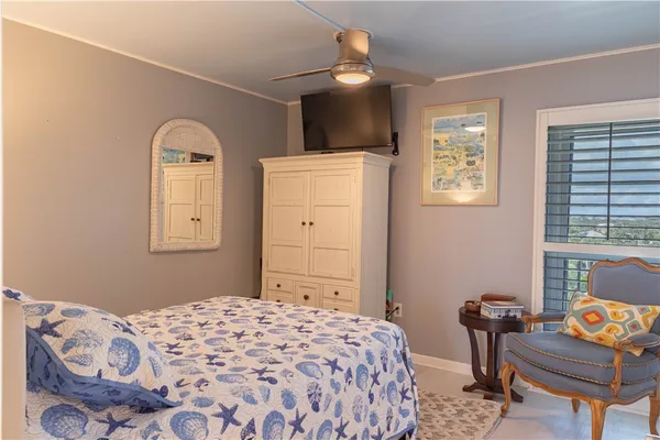 a bathroom with a shower and a toilet sitting next to a window