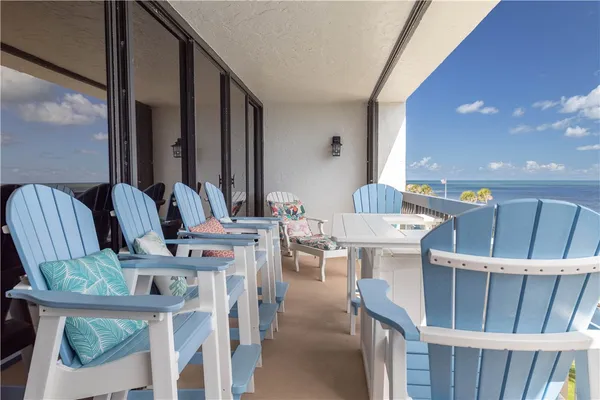 a view of a dining room with furniture and floor to ceiling window