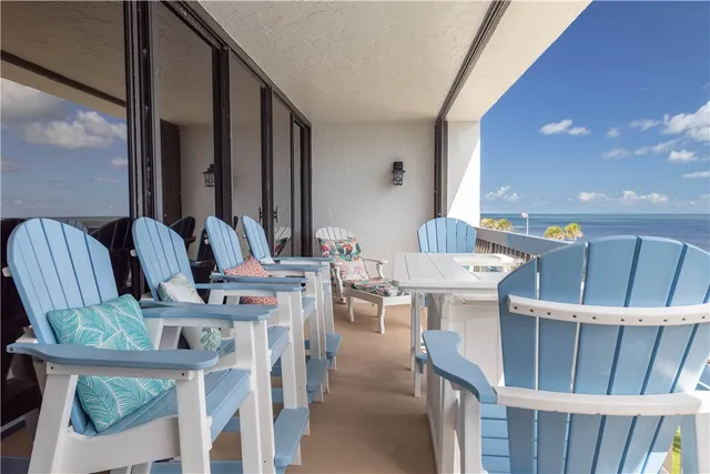 a view of a dining room with furniture and floor to ceiling window