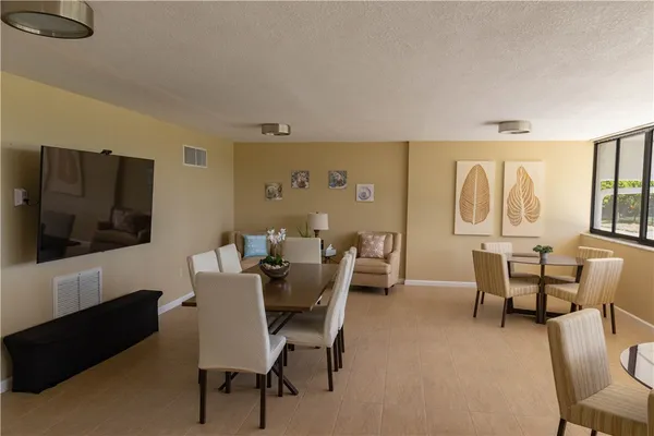 a kitchen with refrigerator cabinets and chairs