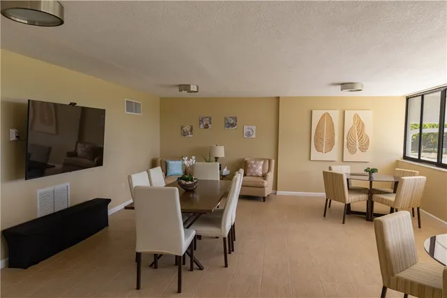 a kitchen with refrigerator cabinets and chairs