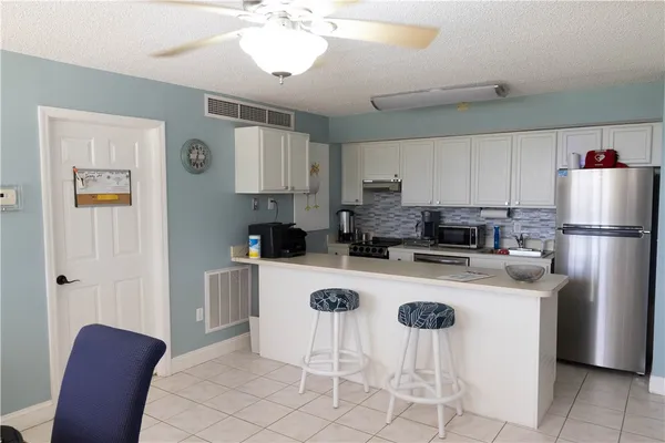 a view of a livingroom with furniture and a large window