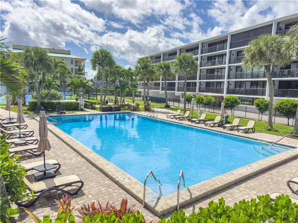 a view of a swimming pool with an outdoor seating