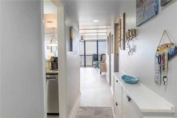 a kitchen with granite countertop stainless steel appliances a sink a stove a microwave and wooden cabinets