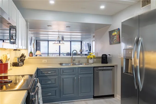 a kitchen with a refrigerator and a window