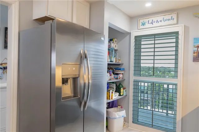 a kitchen with a table chairs refrigerator and cabinets