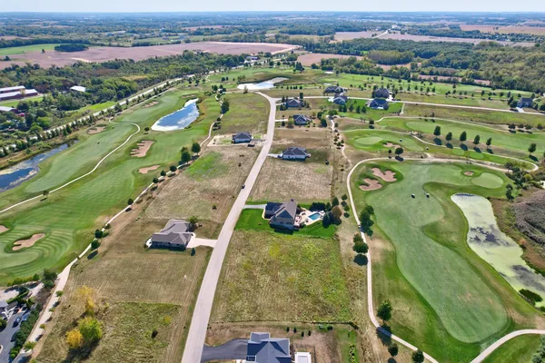 an aerial view of a house with a yard