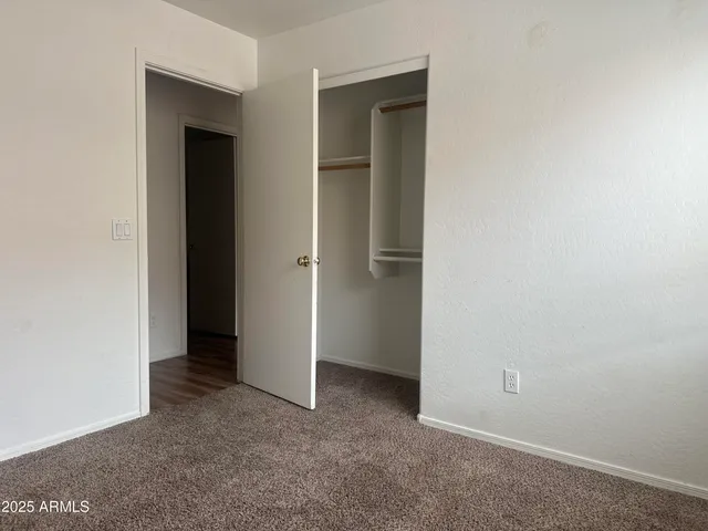 an empty room that has a grey walls
