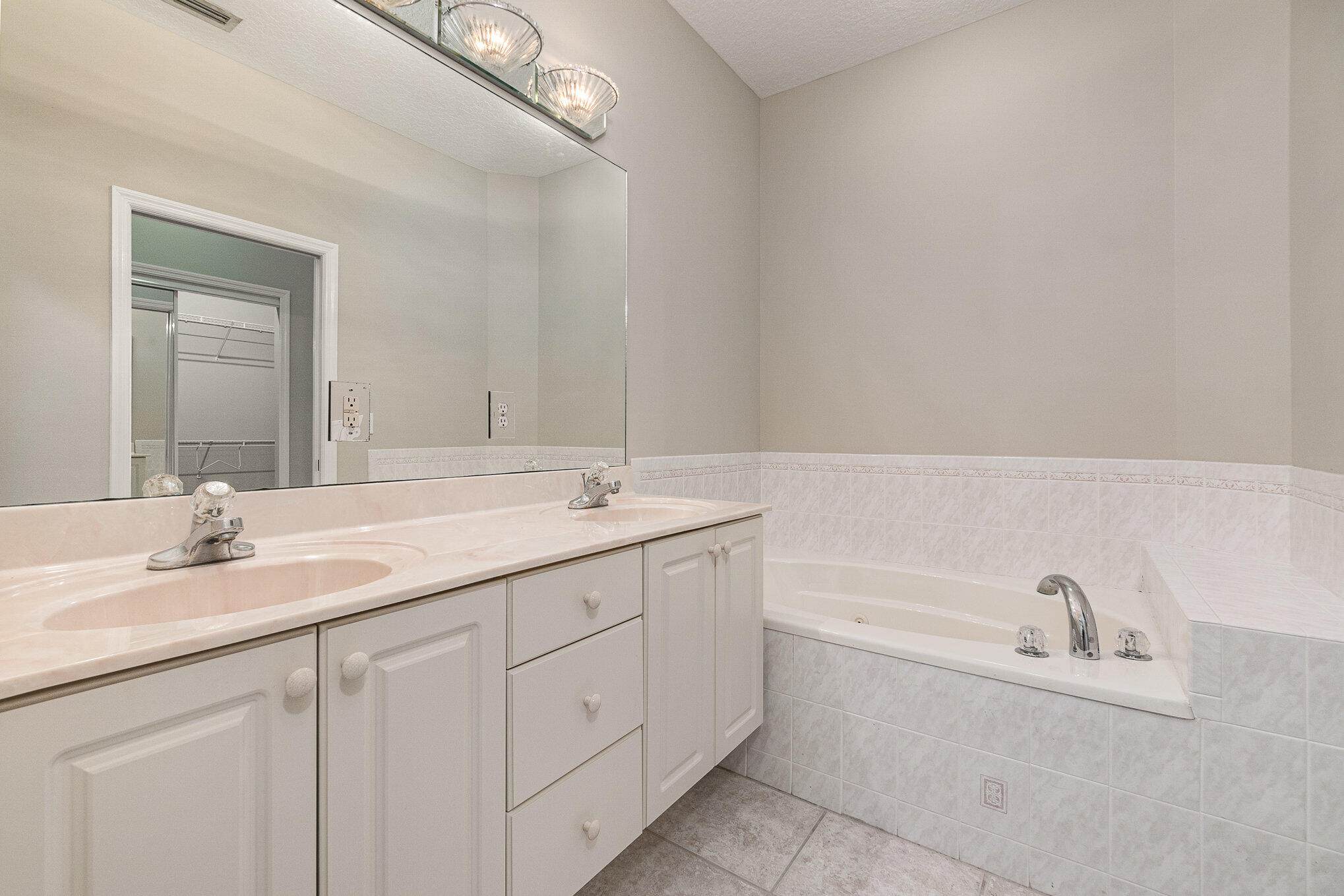 4370 Aberdeen Circle Rockledge, FL 32955 - Photo 14 of 33 a bathroom with a bathtub sink double vanity and mirror