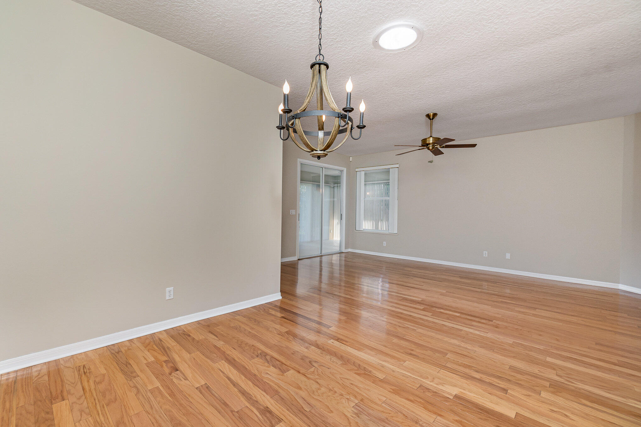 4370 Aberdeen Circle Rockledge, FL 32955 - Photo 7 of 33 a view of empty room with wooden floor and ceiling fan