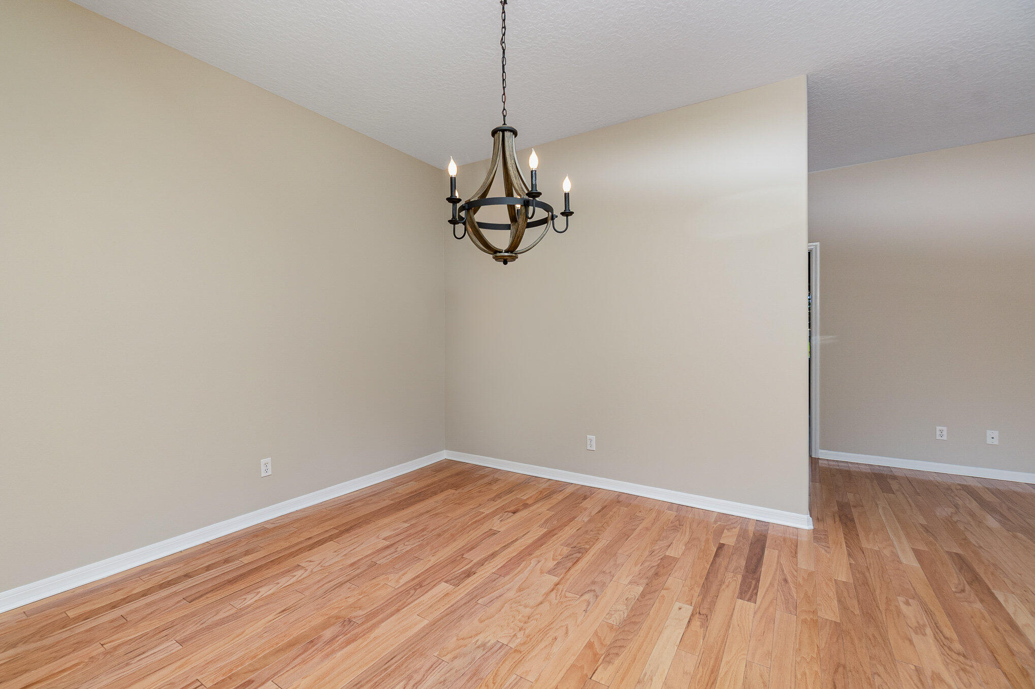 4370 Aberdeen Circle Rockledge, FL 32955 - Photo 8 of 33 a view of a room with wooden floor and chandelier