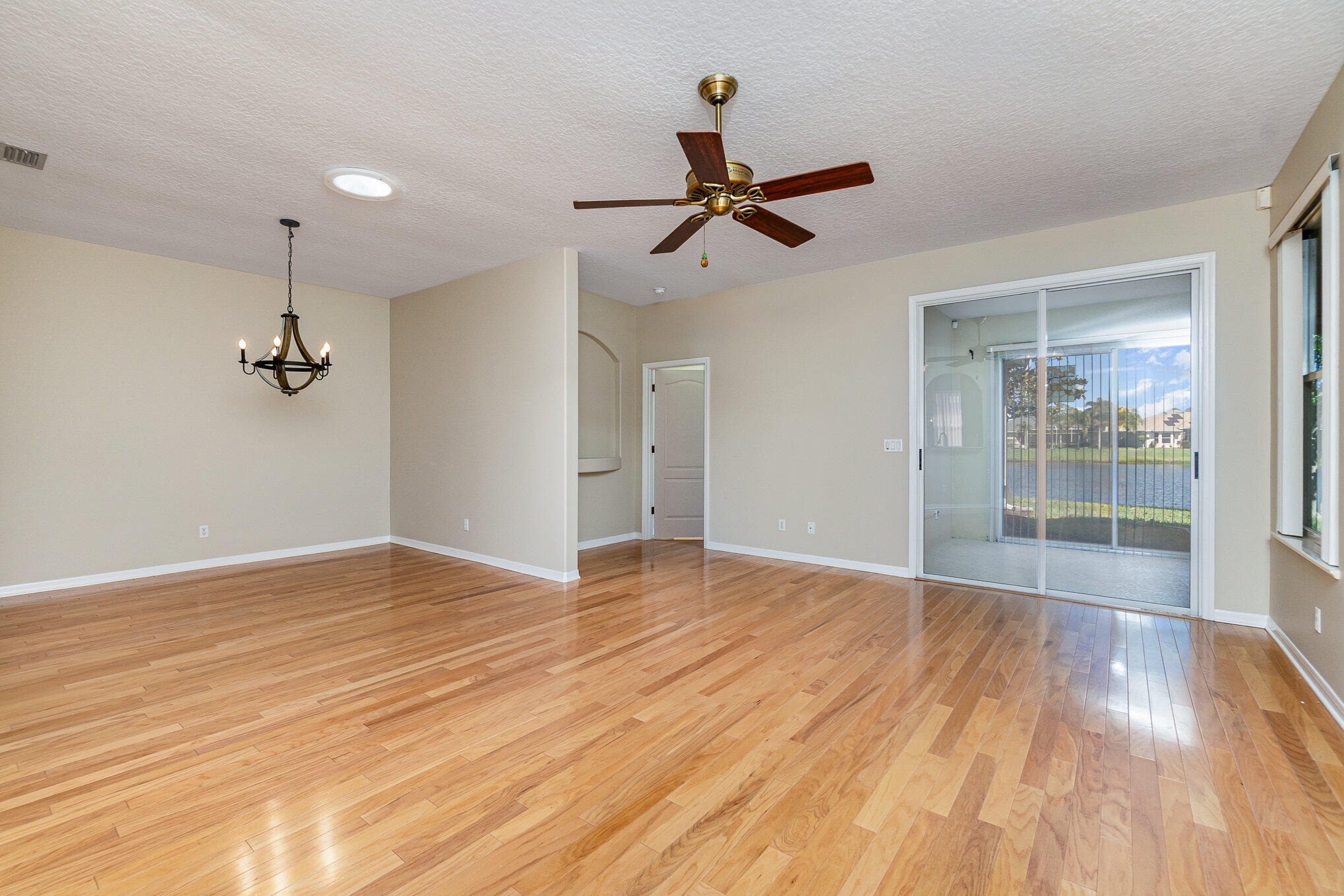 4370 Aberdeen Circle Rockledge, FL 32955 - Photo 9 of 33 a view of empty room with wooden floor and fan
