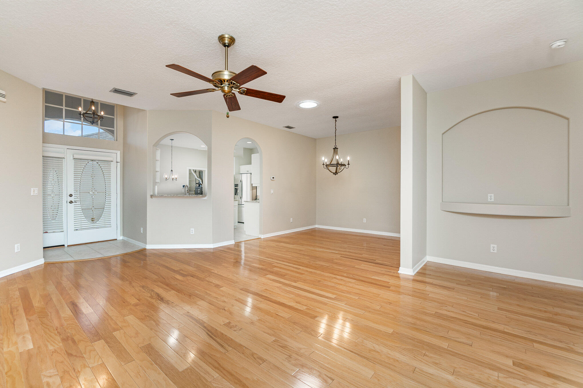 4370 Aberdeen Circle Rockledge, FL 32955 - Photo 10 of 33 a view of empty room with wooden floor and ceiling fan