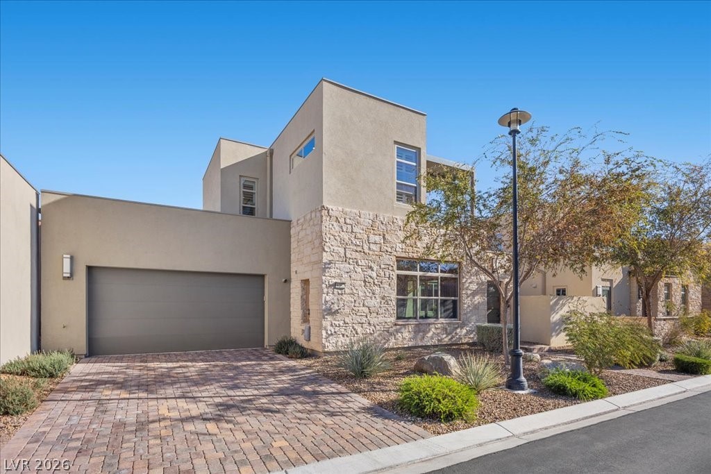 4262 Swift Street Las Vegas, NV 89135 - Photo 2 of 75 View of front of property with stone siding, decorative driveway, and stucco siding