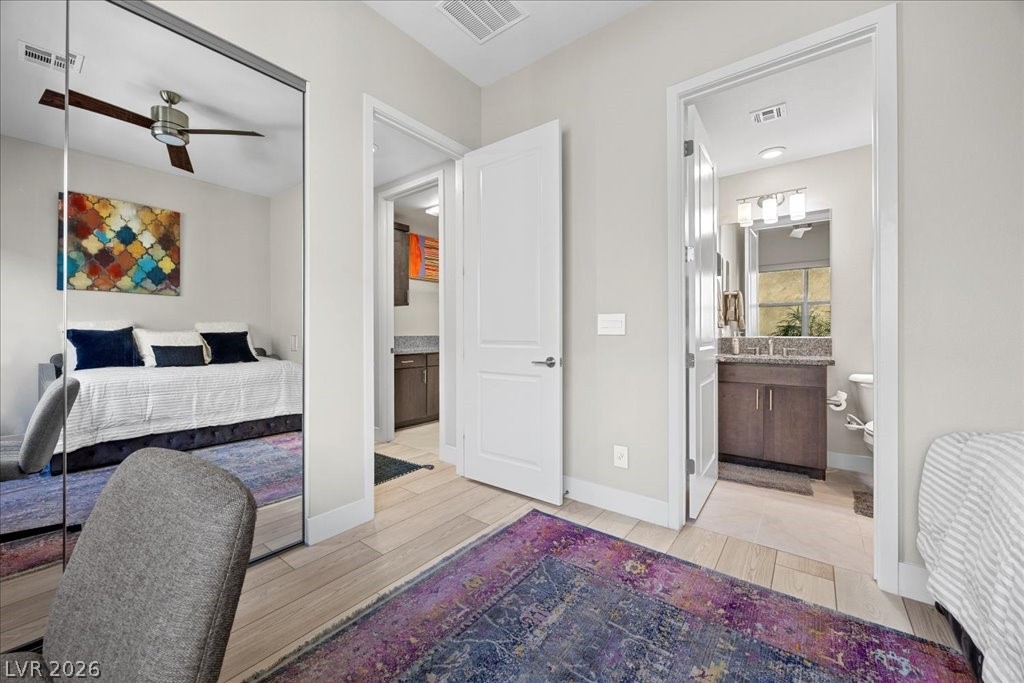 4262 Swift Street Las Vegas, NV 89135 - Photo 25 of 75 Bedroom featuring wood tiled floors, ceiling fan, and ensuite bath