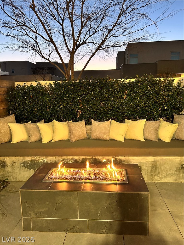 4262 Swift Street Las Vegas, NV 89135 - Photo 6 of 75 Patio terrace at dusk with an outdoor living space with a fire pit and a patio area