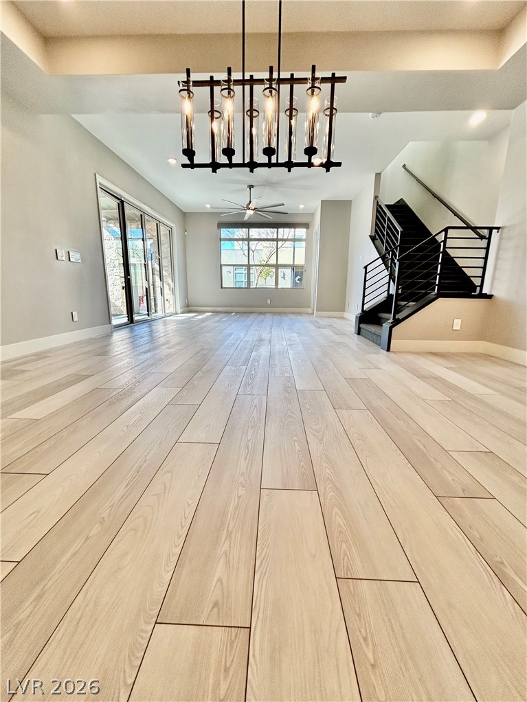 4262 Swift Street Las Vegas, NV 89135 - Photo 62 of 75 Living room featuring light wood-style flooring, a ceiling fan, and hanging lights