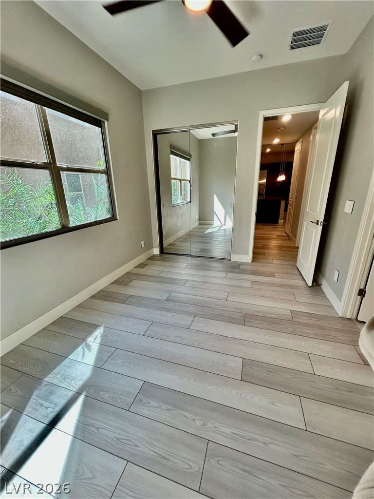 4262 Swift Street Las Vegas, NV 89135 - Photo 65 of 75 Unfurnished bedroom featuring a closet, light wood-type flooring, and ceiling fan