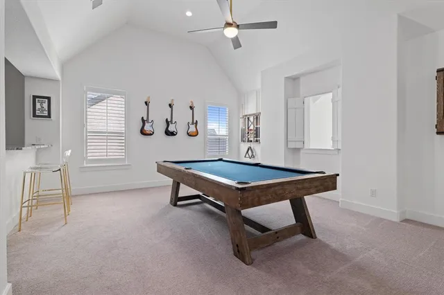 a room with pool table and windows