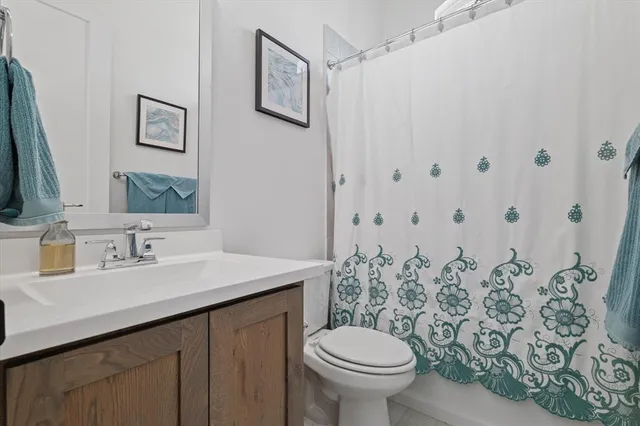 a bathroom with a sink and mirror with toilet