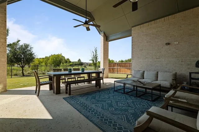a view of a patio with a dining table and chairs