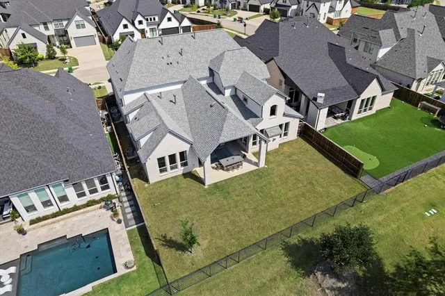 an aerial view of multiple houses with yard