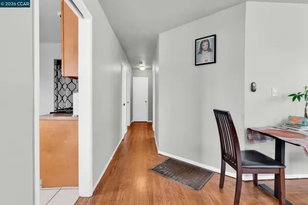 a view of a room with furniture and wooden floor