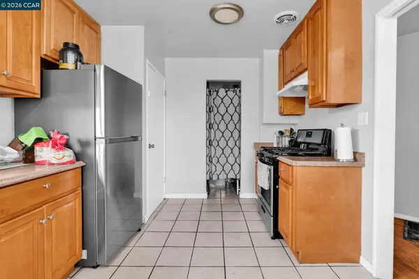 a kitchen with stainless steel appliances granite countertop a refrigerator and a stove