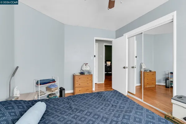 a bedroom with furniture and a wooden floor