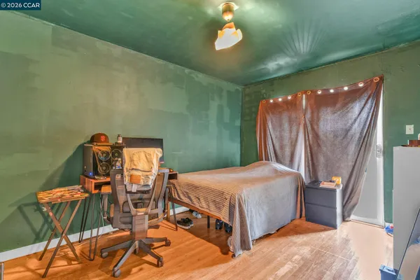 a bedroom with a bed and a chandelier