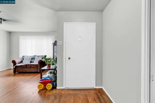 a view of a workspace with furniture and wooden floor
