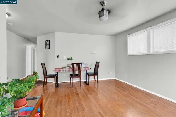 a view of a dining room with furniture and wooden floor