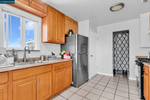 a kitchen with stainless steel appliances a refrigerator sink and cabinets