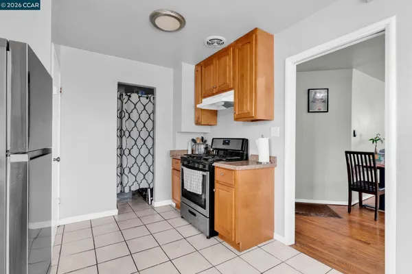 a kitchen with stainless steel appliances granite countertop a refrigerator and a stove