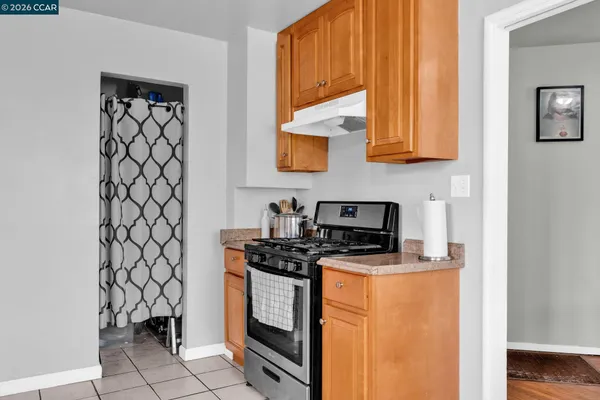 a kitchen with stainless steel appliances a stove a sink and a microwave