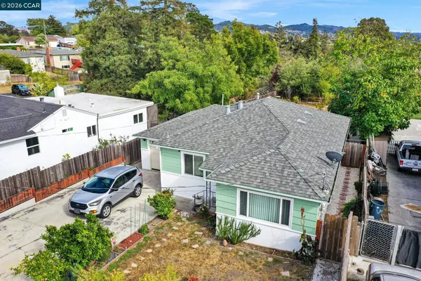an aerial view of a house with a garden and lake view