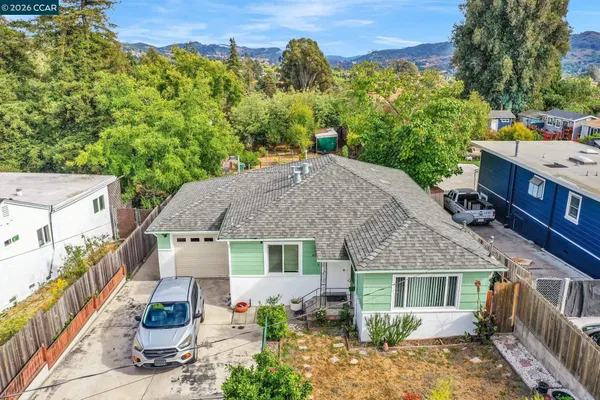 aerial view of a house with a yard and potted plants