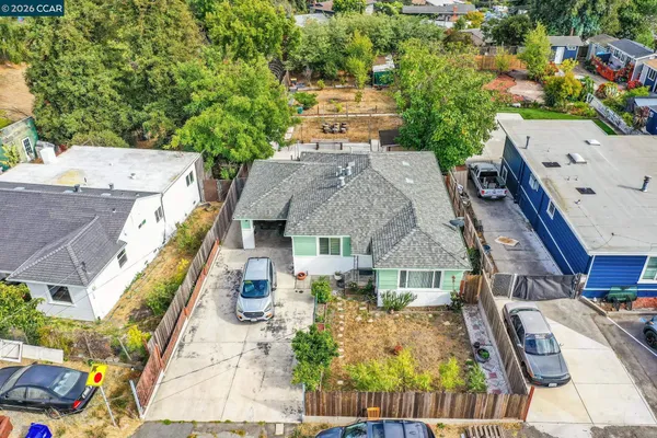 an aerial view of a house with a garden and plants