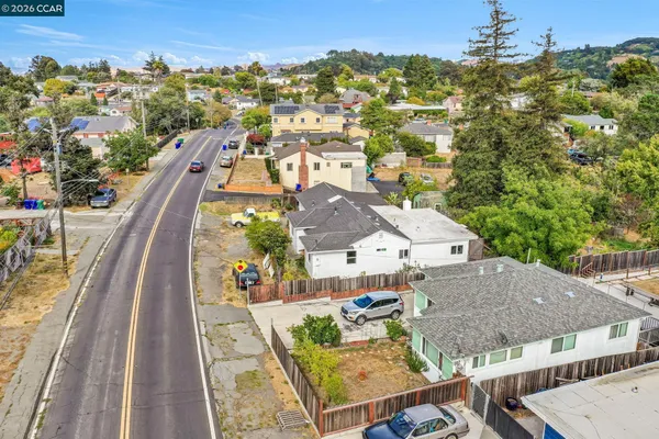 an aerial view of residential houses with outdoor space and seating