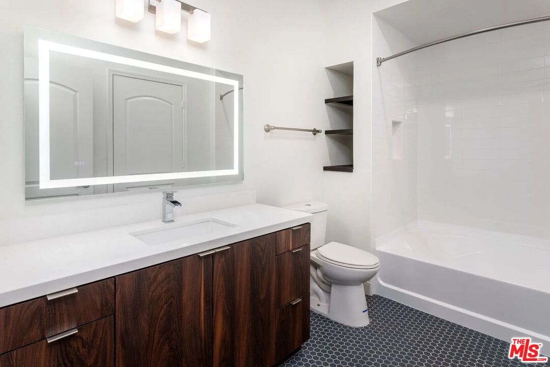5710 Crescent Park East, Unit 324 Playa Vista, CA 90094 - Photo 13 of 29 a bathroom with a sink a toilet a mirror and shower