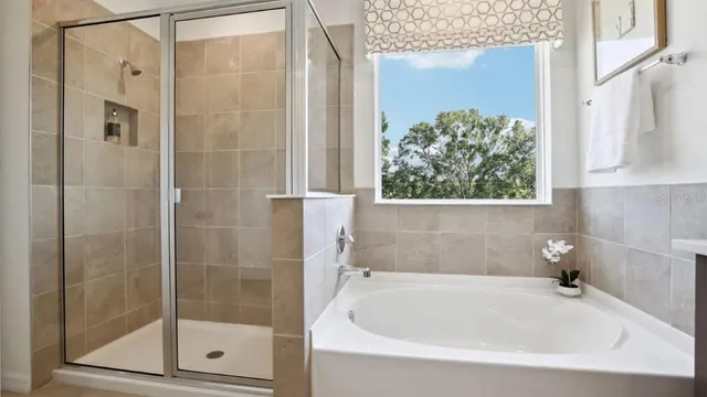 a white bath tub sitting next to a shower