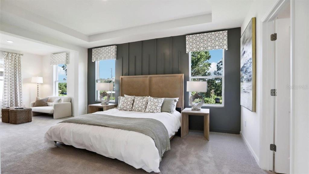 2425 Stratten Drive Zephyrhills, FL 33541 - Photo 22 of 28 a bedroom with a bed couch and a large window